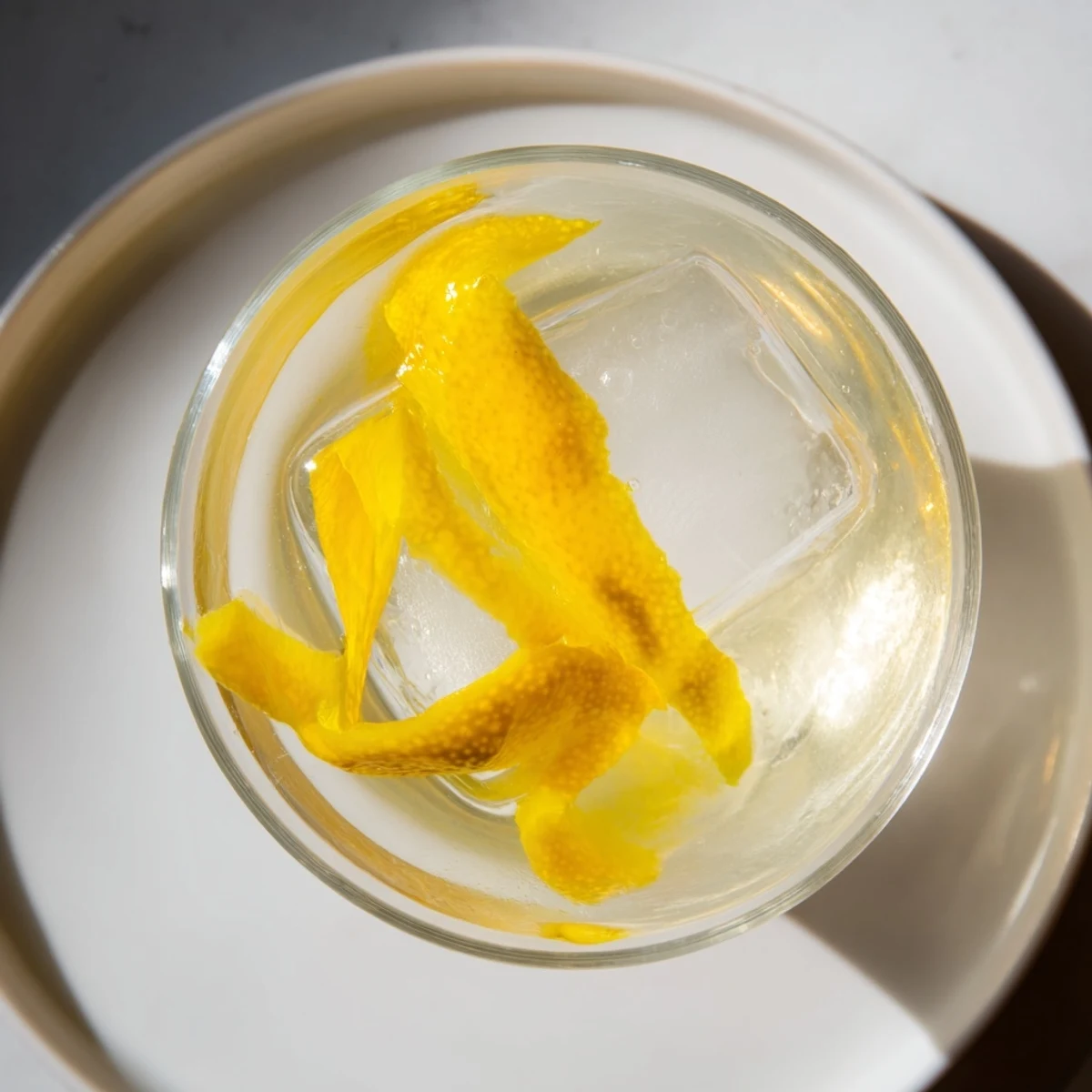 Imagine a vibrant Lemon Twist, the vodka glistening, served in a stylish coupe glass.