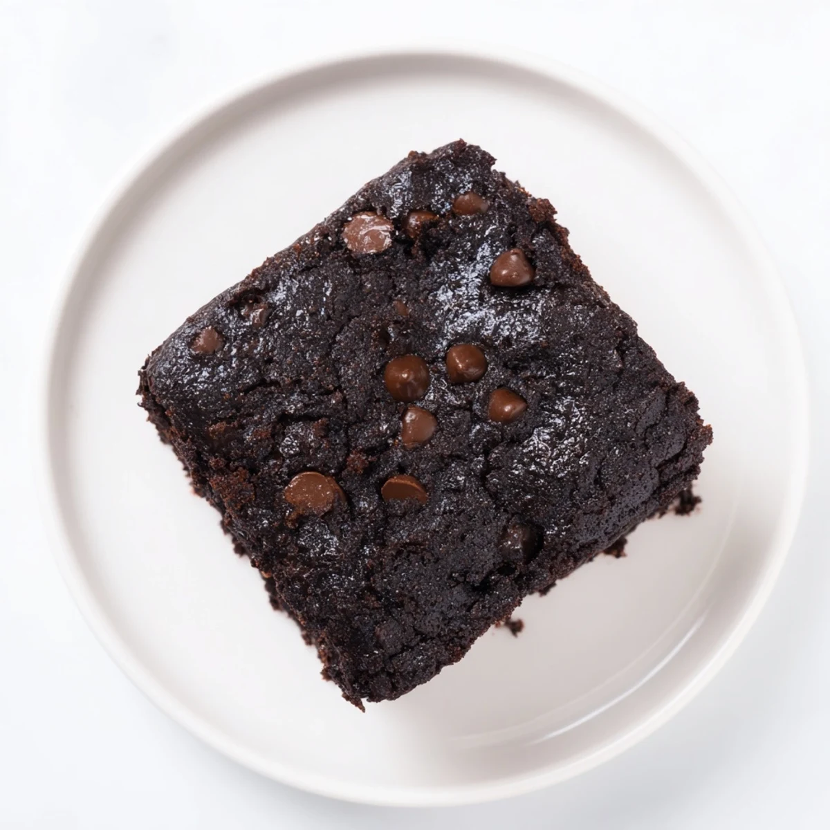 Freshly baked Chocolate Fudge Brownies, featuring a crackly top, promise a rich, intensely chocolate experience.