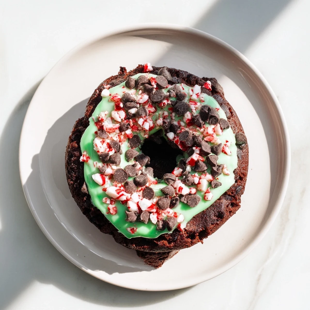 Delicious Peppermint Mocha Donuts glistening with a creamy peppermint glaze, ready to be enjoyed.