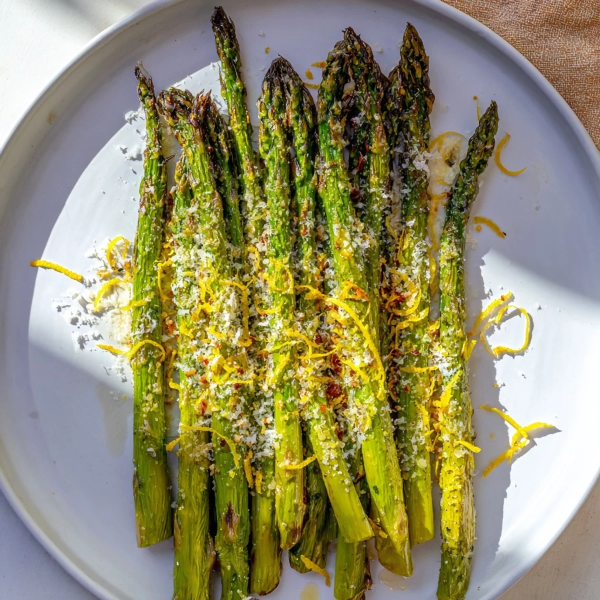 Freshly roasted asparagus glistening with olive oil and lemon zest, a perfect vegetarian delight.