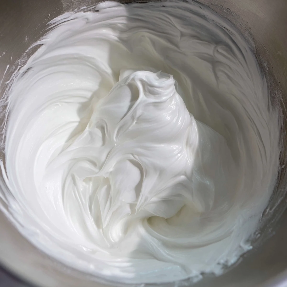 Homemade gingerbread house icing, a smooth, vibrant texture for gluing gingerbread together seamlessly.