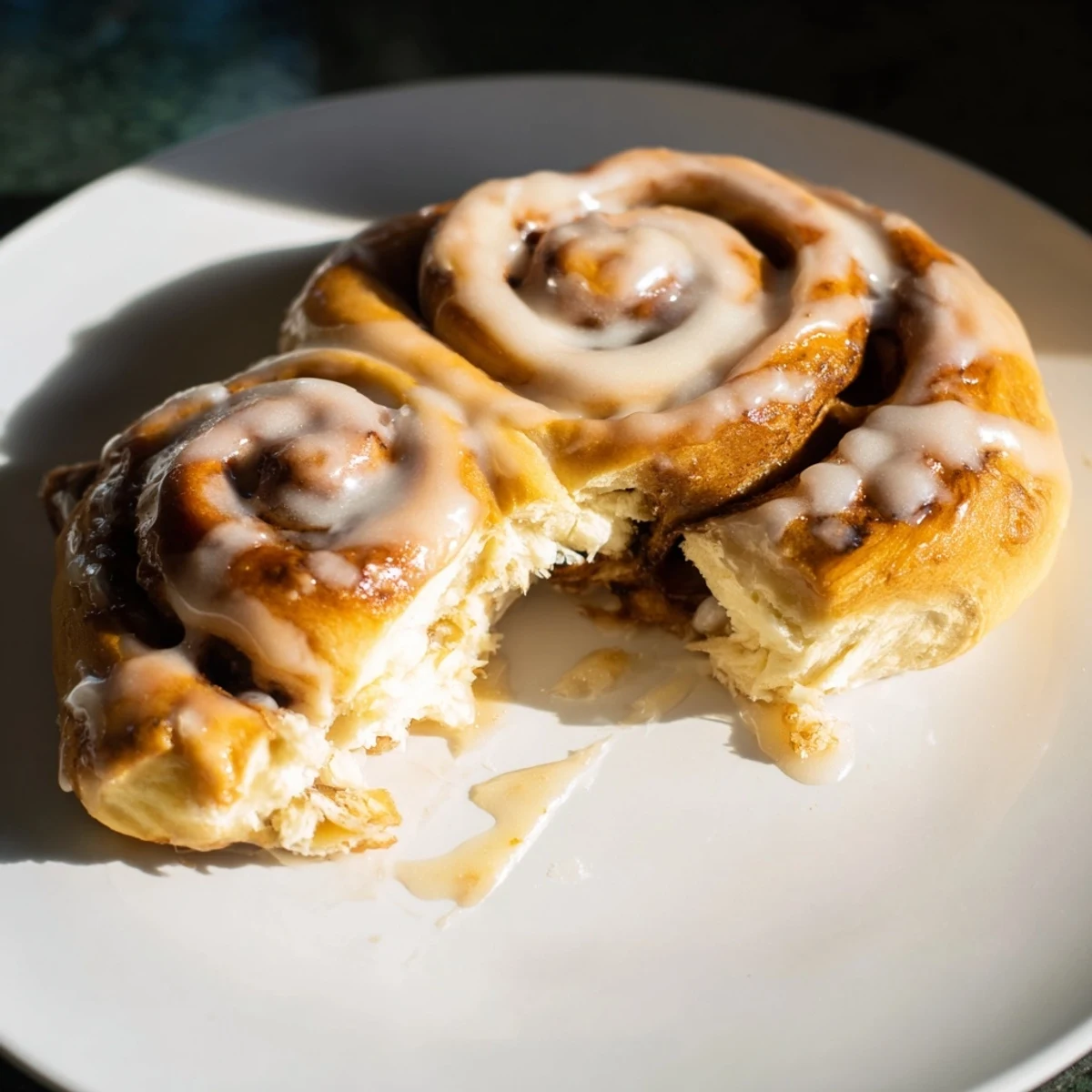 Homemade Cinnamon Swirl Buns, showing soft layers and a glistening glaze, ready for enjoying.