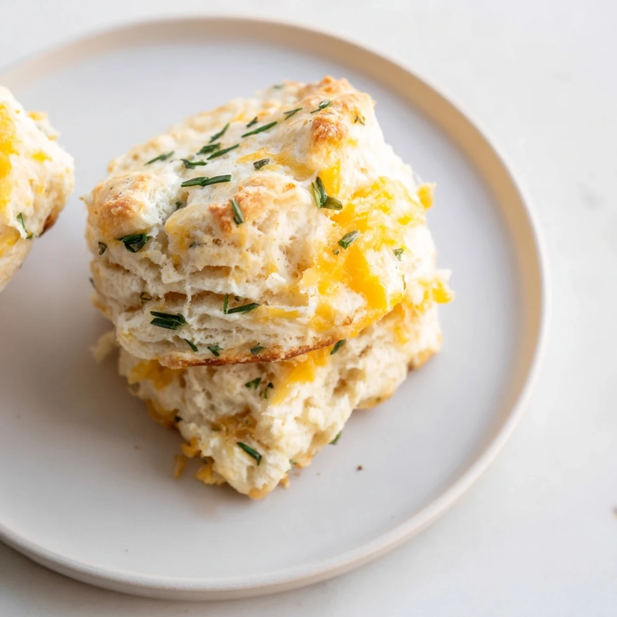 A close-up shot of homemade savory biscuits showcases their flaky texture and inviting smell.