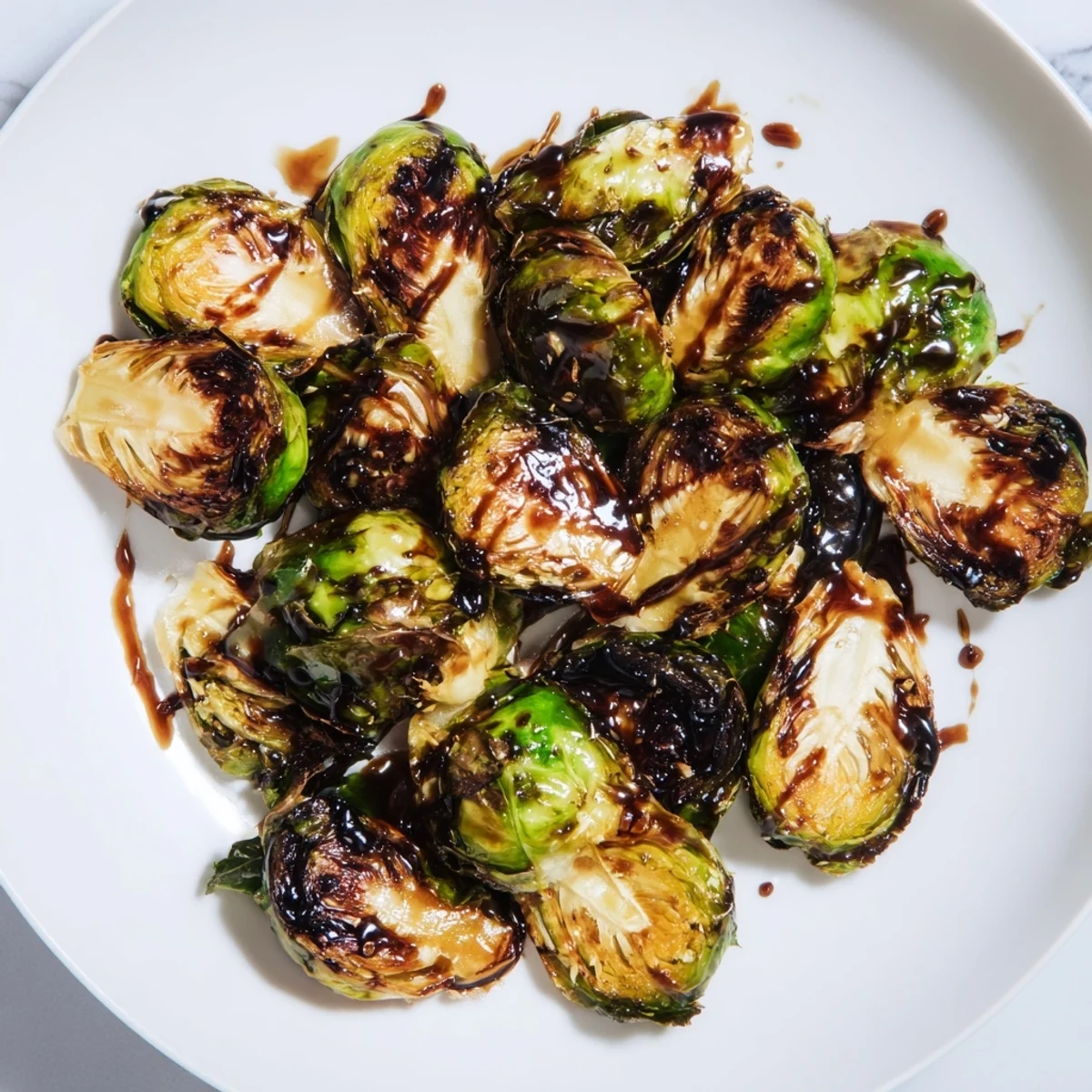 Crispy-edged Roasted Brussels Sprouts, glistening with balsamic glaze; a perfect vegetarian dinner addition.