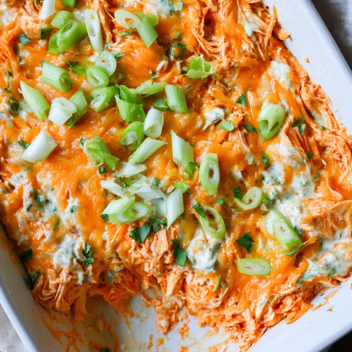A warm, creamy Spicy Buffalo Chicken Dip with shredded chicken and melted cheese, ready to scoop with tortilla chips.