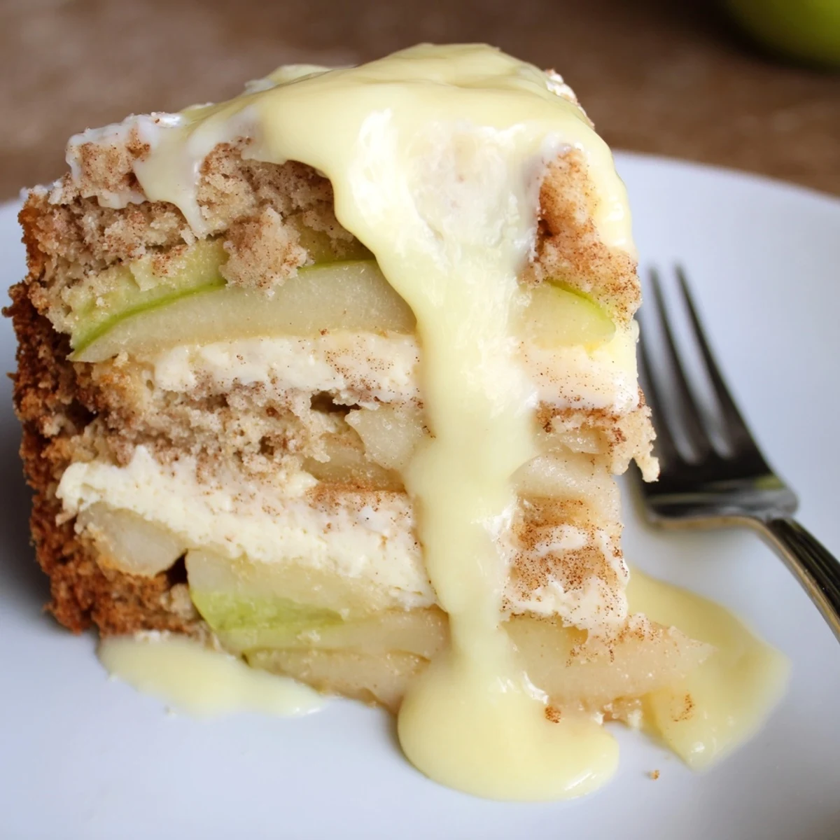 Freshly baked Irish Apple Cake with Custard Sauce is served warm, vanilla custard cascading over tender apple slices, perfect for a cozy teatime dessert.