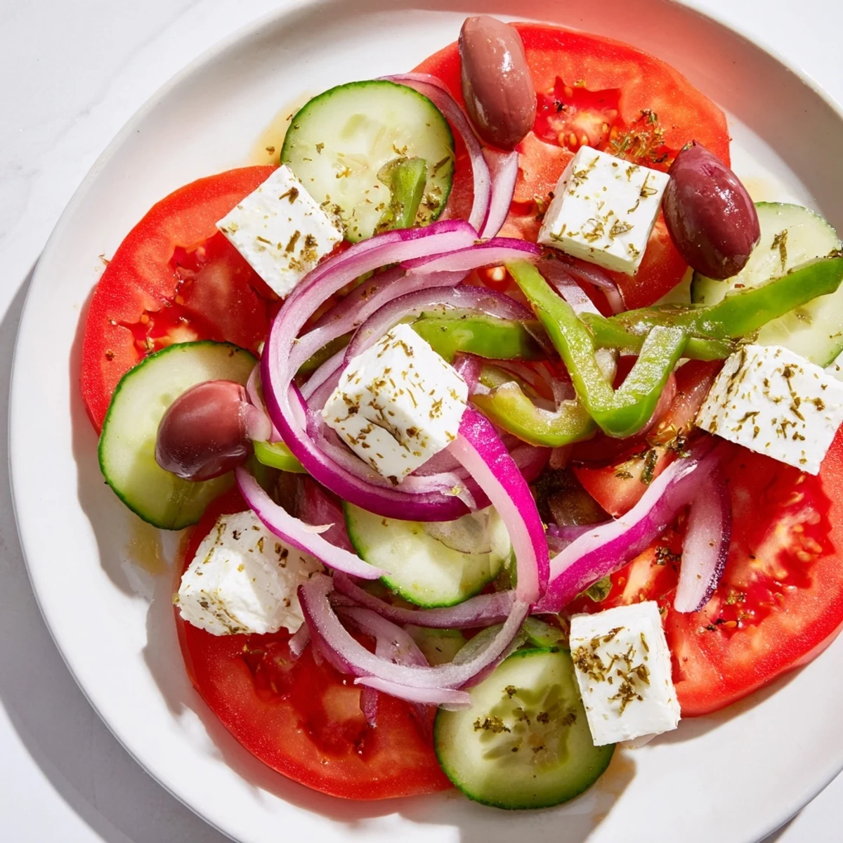 A close-up of a vibrant Greek salad with Kalamata olives and feta, featuring crisp vegetables and glistening olive oil dressing.
