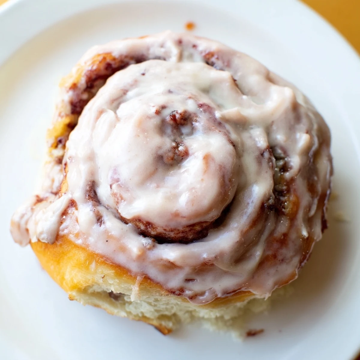 Freshly baked Sweetheart Cinnamon Rolls with gooey cinnamon filling and smooth, swirls of pink icing.