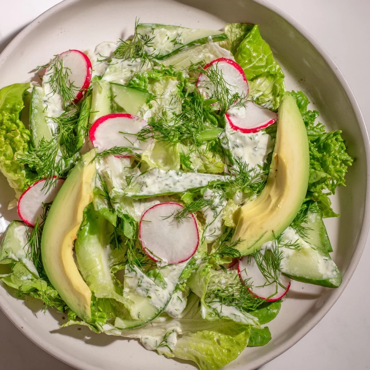 Green Salad with Green Goddess Dressing showcases tossed greens, snap peas, and herbs in a bright, herby dressing, ready for a light lunch.