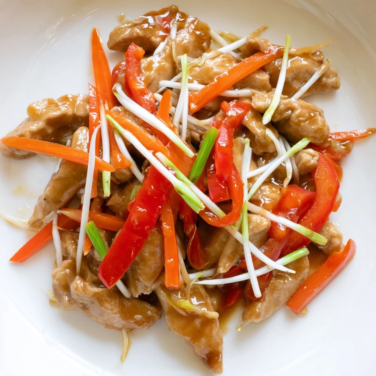Vibrant Peking Style Chicken stir-fry showcases tender chicken and colorful veggies glazed in glossy sauce.  