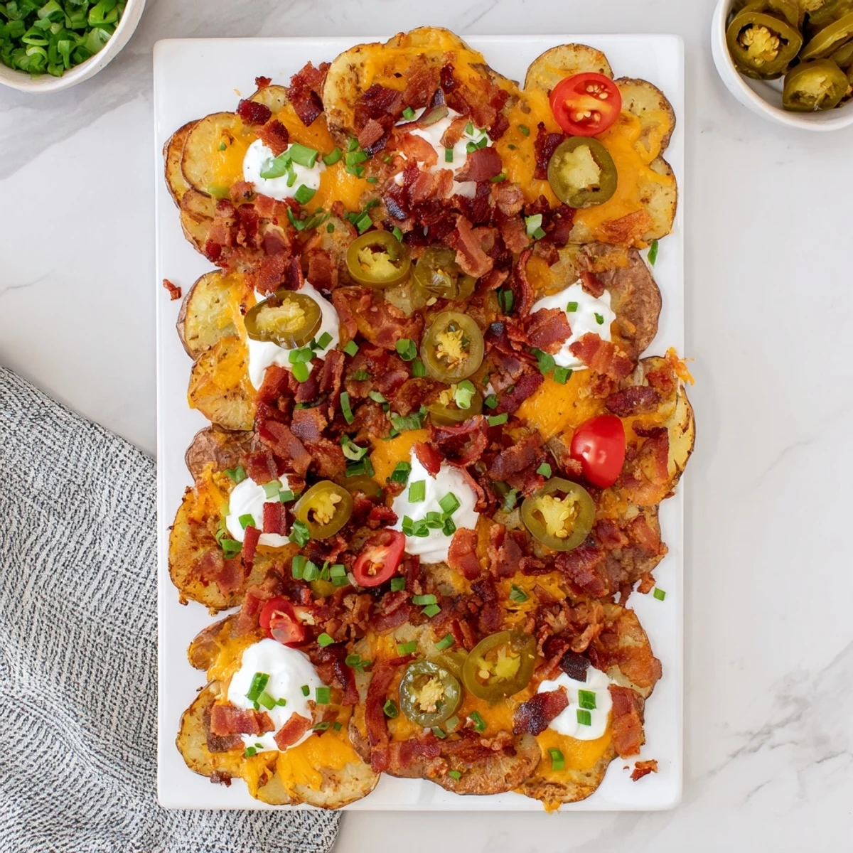 A pub-style platter of Irish Nachos topped with tomatoes and parsley, ready to share.