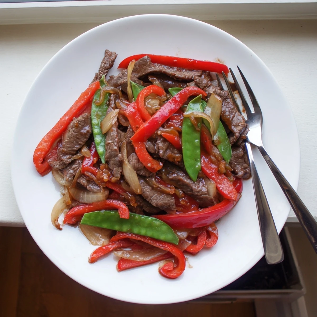 Freshly cooked Beef With Oyster Sauce in a wok, highlighting the savory aroma of garlic, ginger, and the rich oyster sauce glaze.