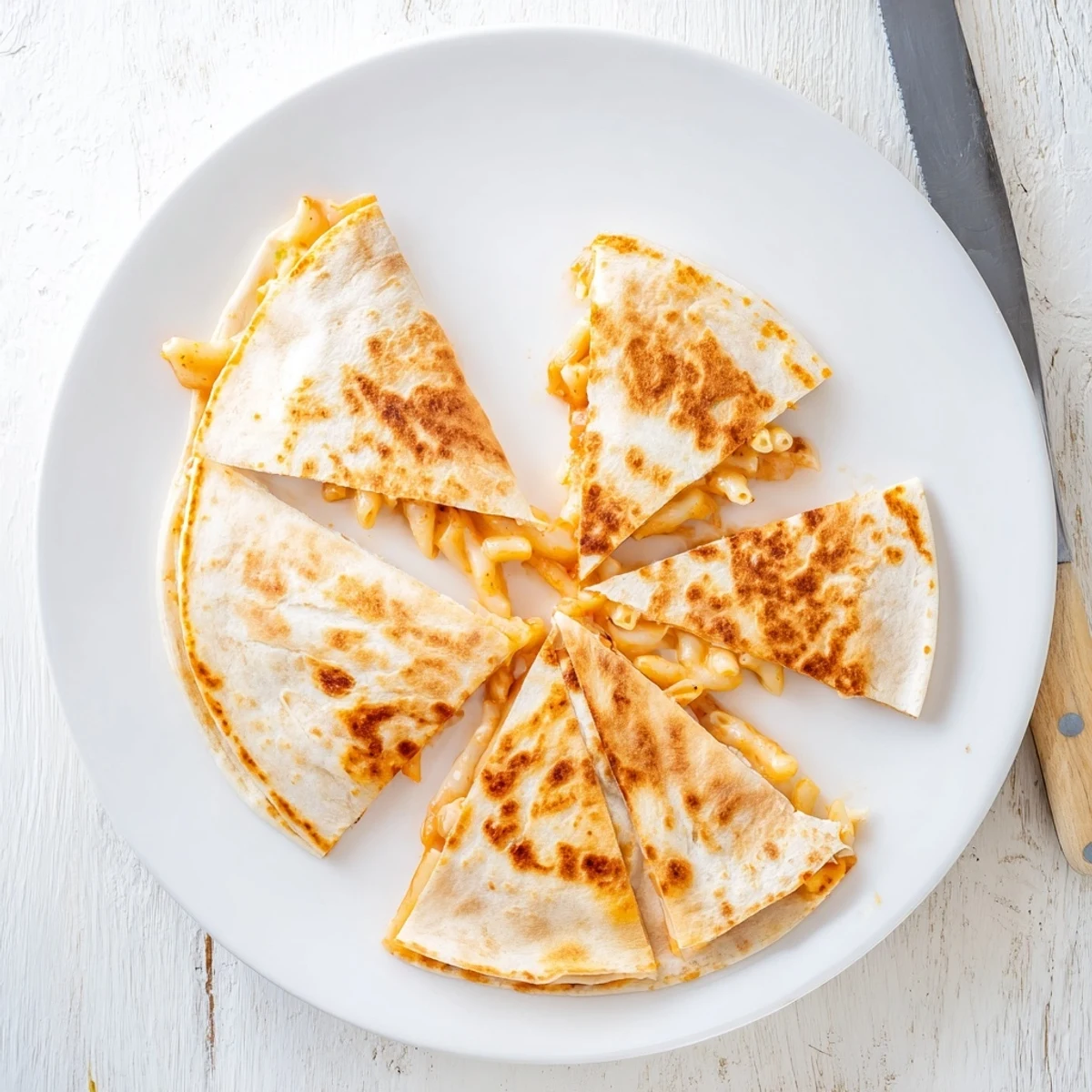 Golden crispy mac and cheese quesadillas oozing melted cheddar on a wooden board
