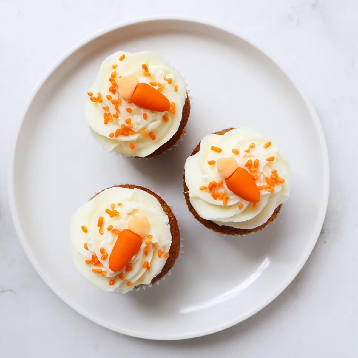 Colorful assortment of easy Easter desserts including carrot cupcakes, bunny cookies, and chocolate nests arranged on a festive spring table