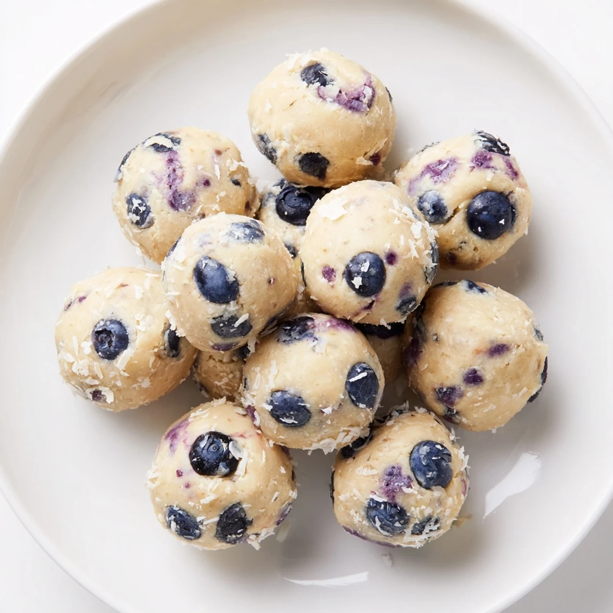 Creamy blueberry cheesecake protein balls with visible blueberry pieces ready for snacking