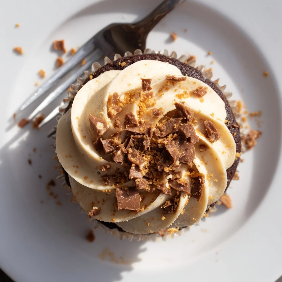 Chocolate cupcakes filled with creamy peanut butter and topped with Butterfinger pieces