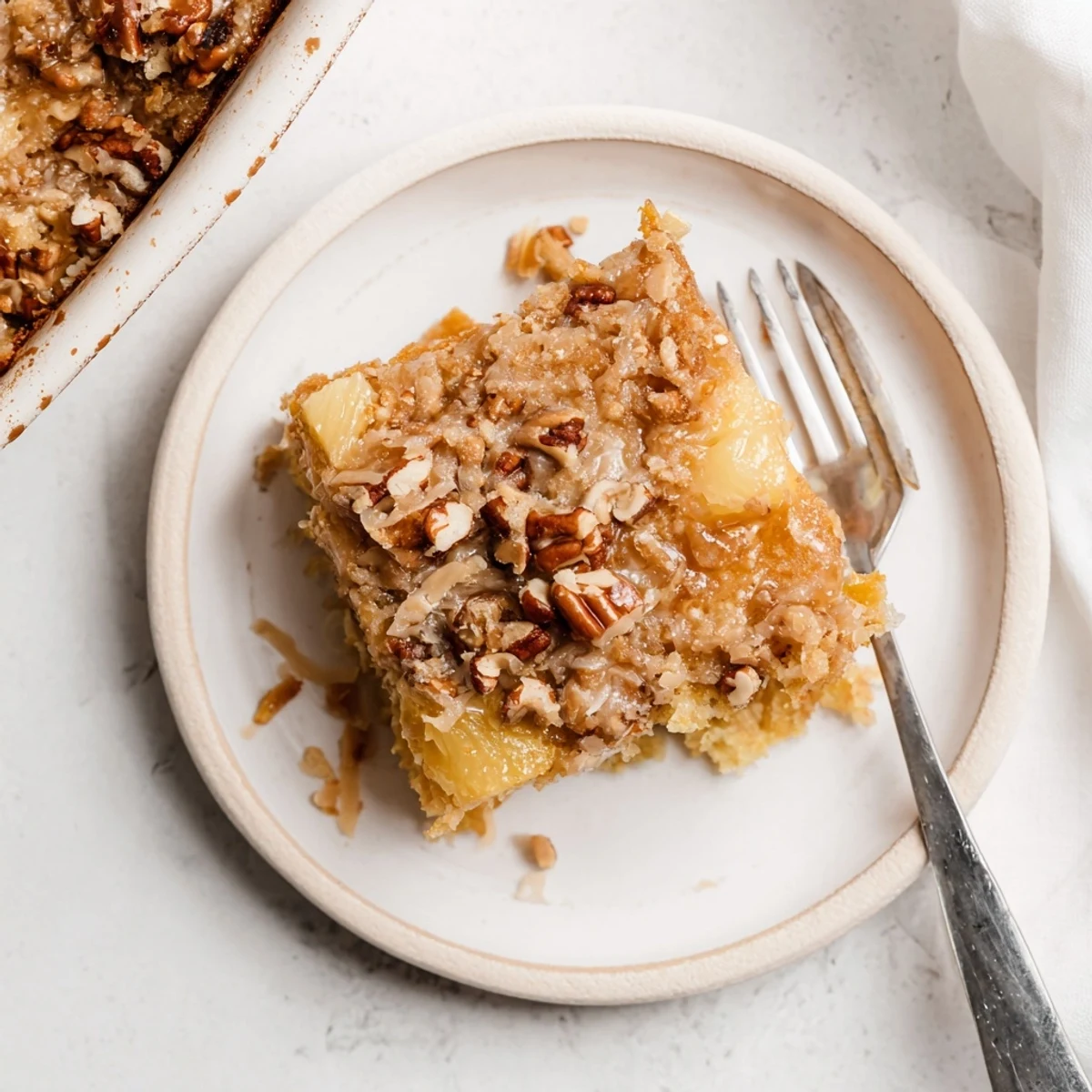 Sliced Texas Tornado Cake displaying layers of pecans and coconut under glaze