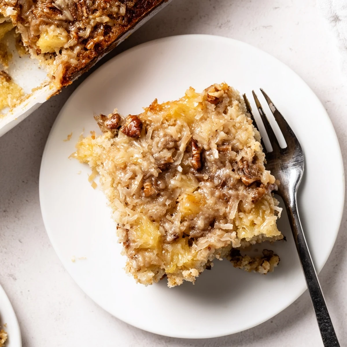 Moist Southern pineapple coconut cake soaked in rich vanilla cream topping