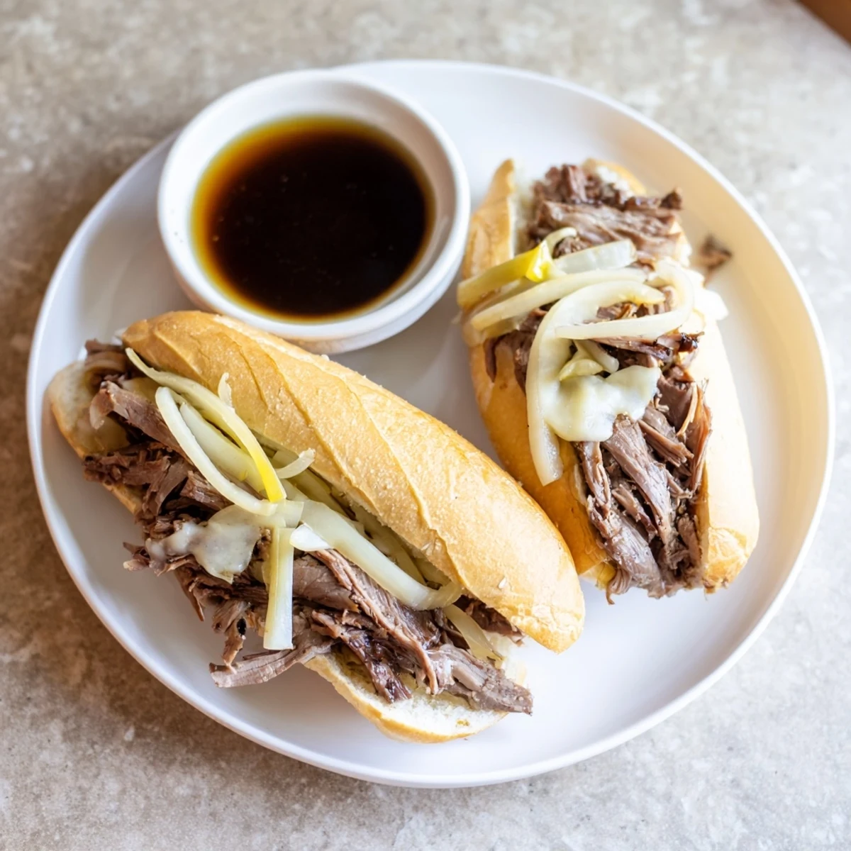 Golden hoagie rolls filled with juicy beef from Crockpot French Dip Sandwiches ready for a hearty dinner