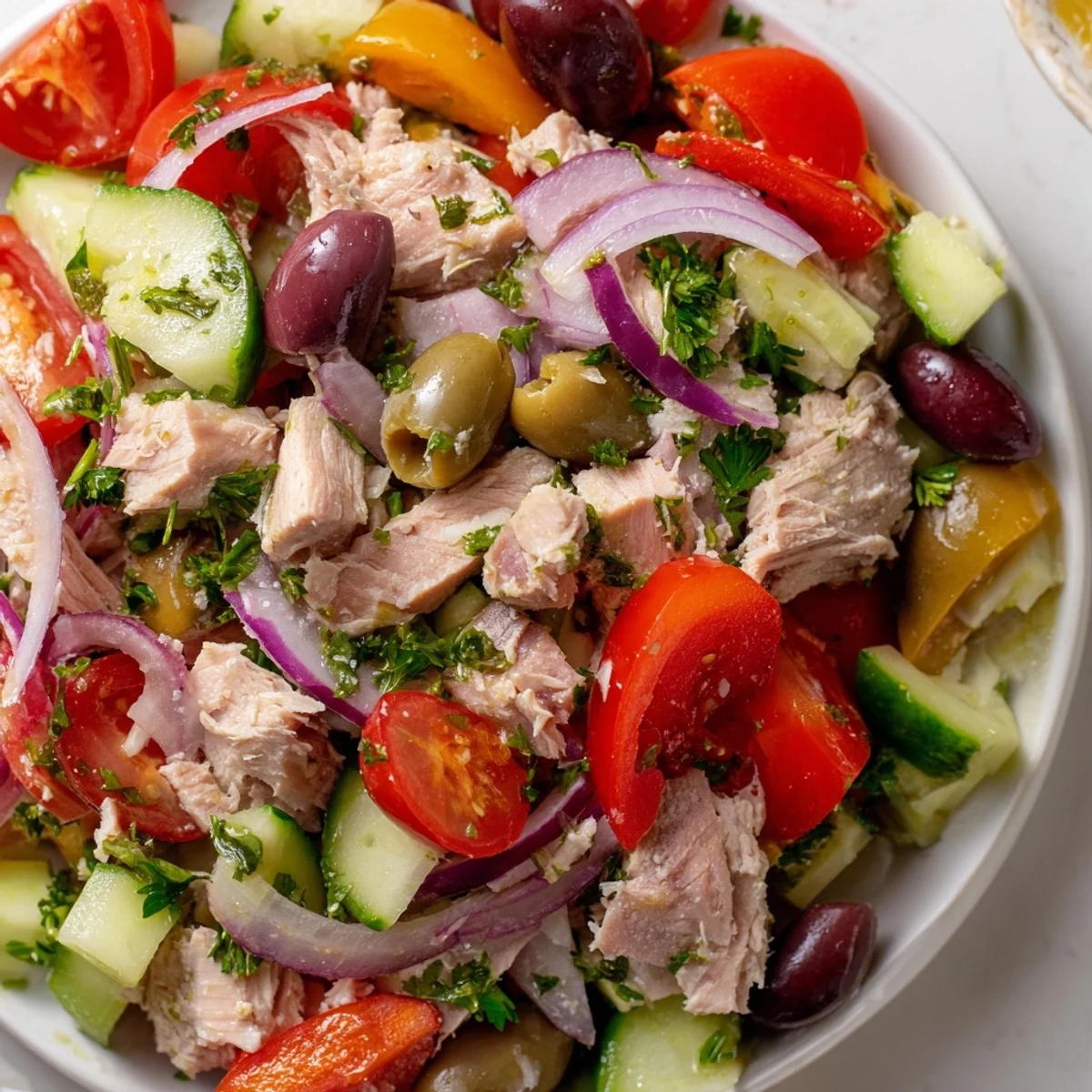 Mediterranean tuna salad topped with crisp cucumber, roasted peppers, and zesty lemon dressing