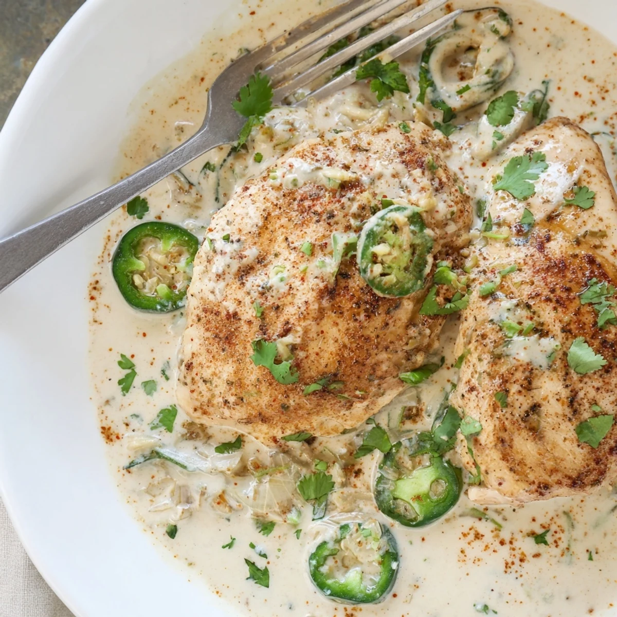 Creamy jalapeno chicken with golden seared breasts smothered in spicy cheese sauce