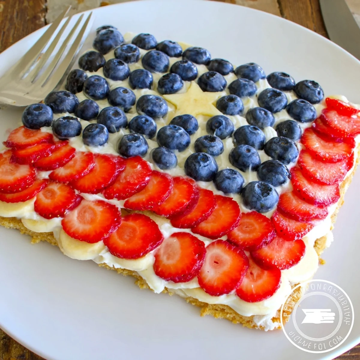 American Flag Fruit Pizza on cooling rack, glossy berries and sliced bananas