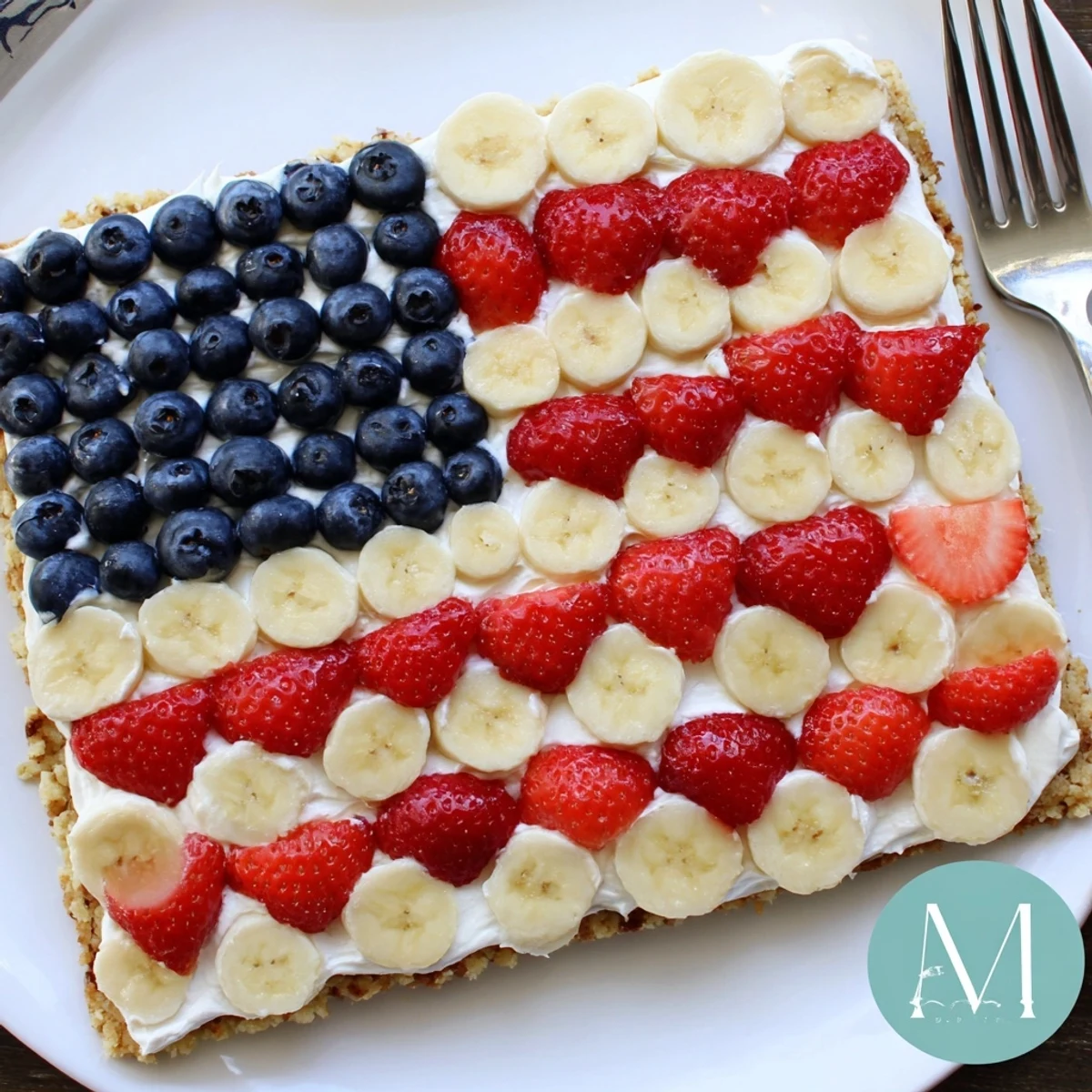 Chilled American Flag Fruit Pizza with creamy frosting and vibrant fruit stripes