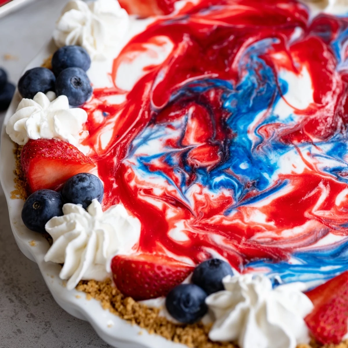 Close-up of Patriotic Red White And Blue Swirl Pie vibrant swirls, graham crust