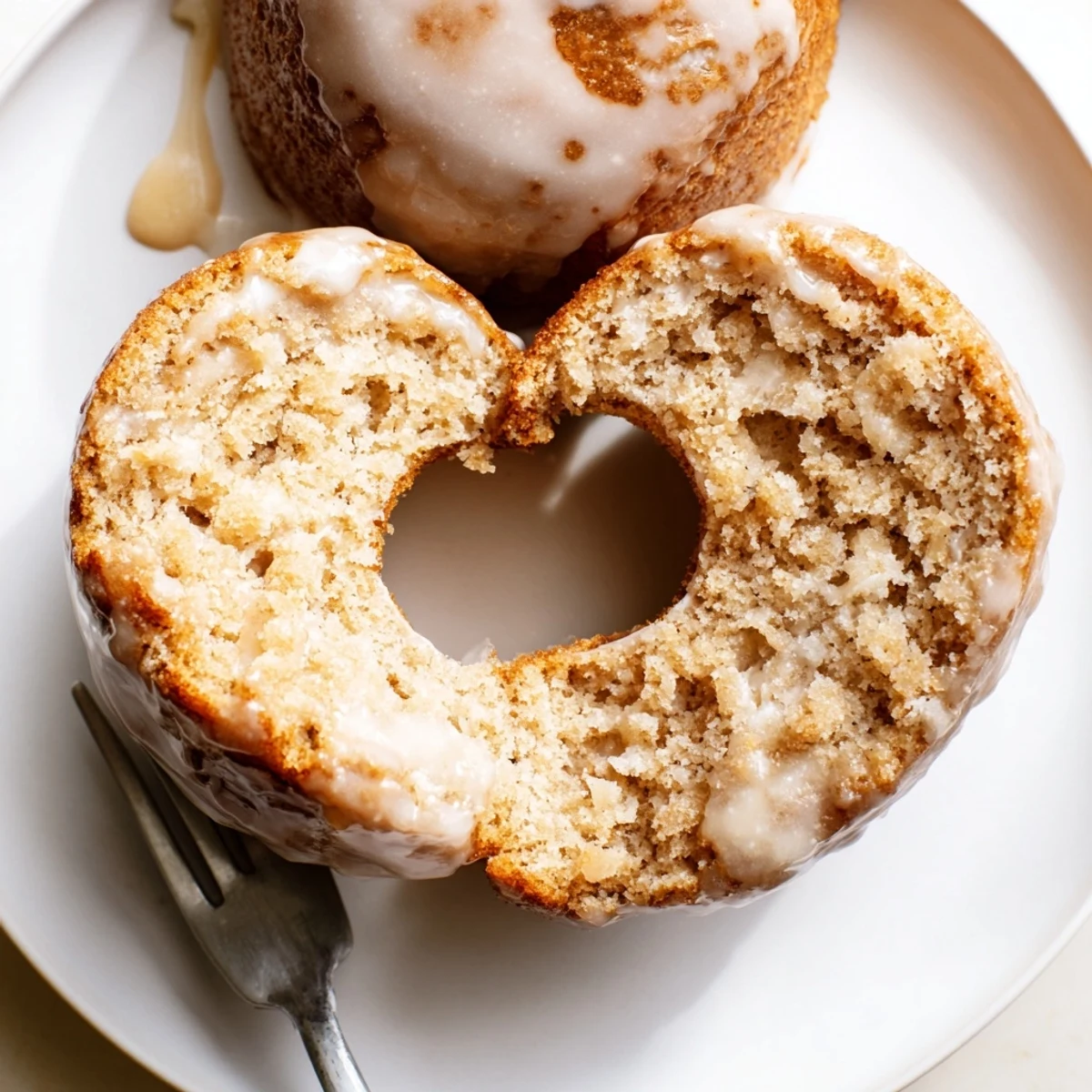 Stacked Banana Donuts served with coffee, tender moist centers and glossy glaze