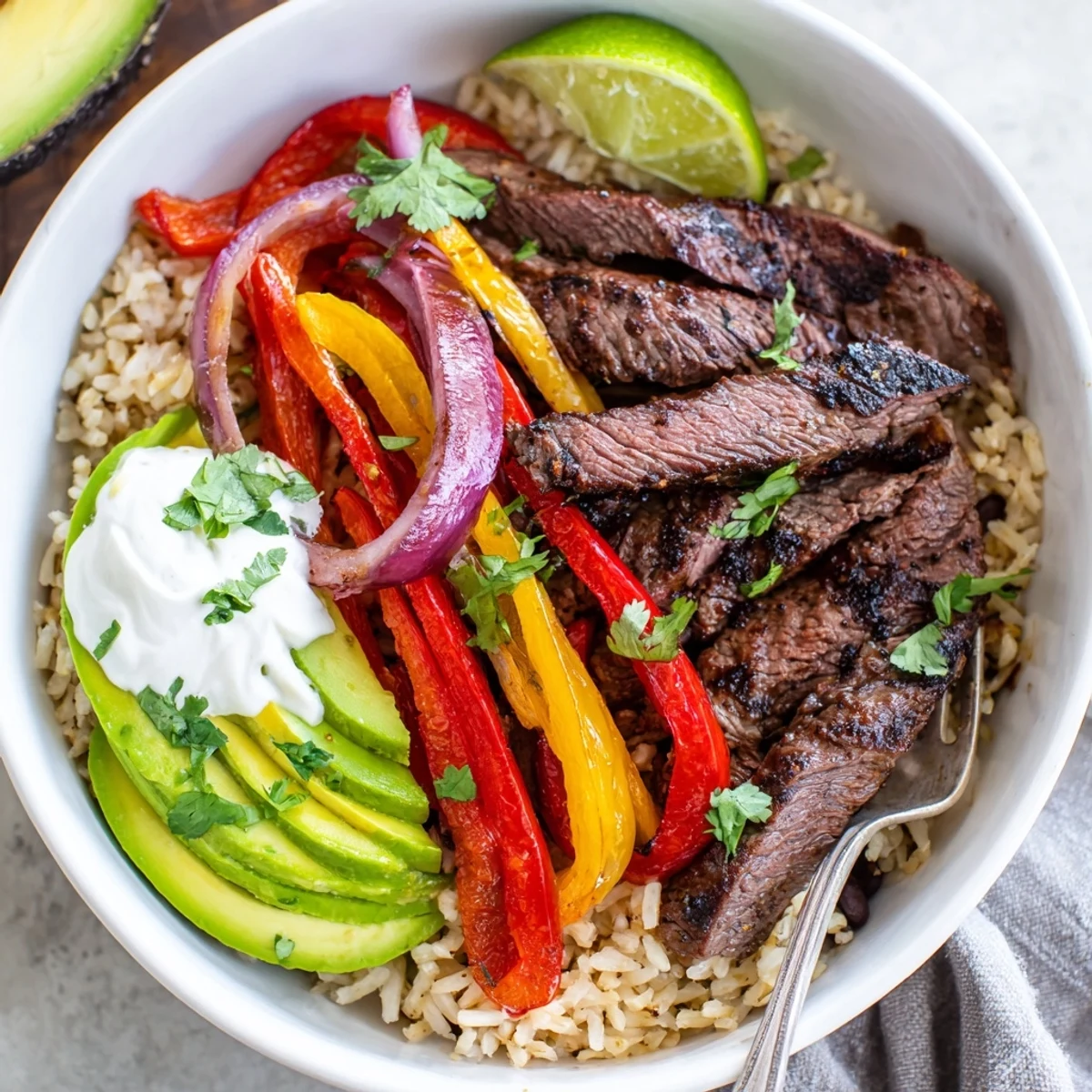 Bright Steak Fajita Power Bowls layered over warm brown rice and black beans