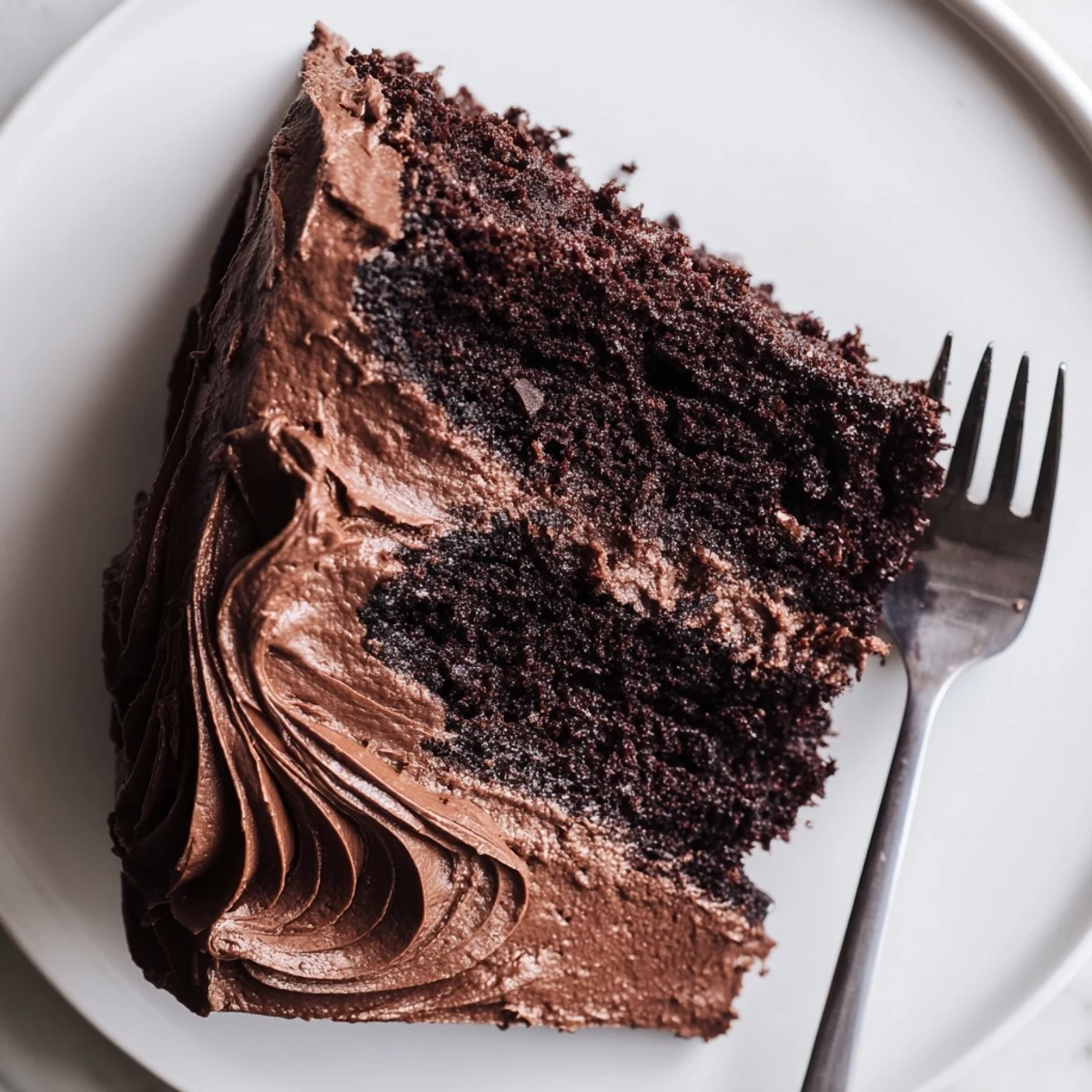Two-layer Matilda chocolate cake featuring smooth buttercream and fudgy moist chocolate crumb.