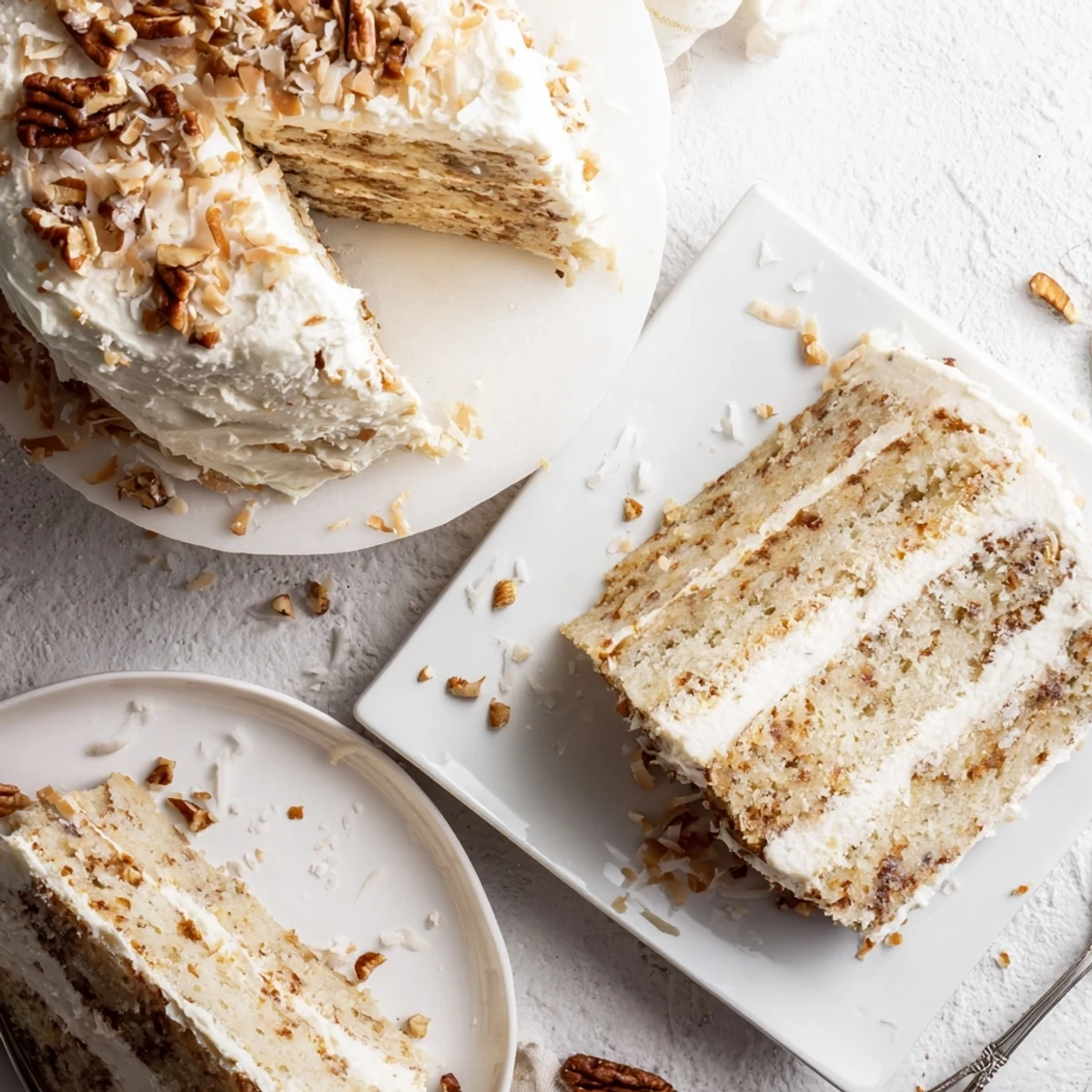 Golden slice of Quick Italian Cream Cake topped with coconut pecans and creamy white frosting