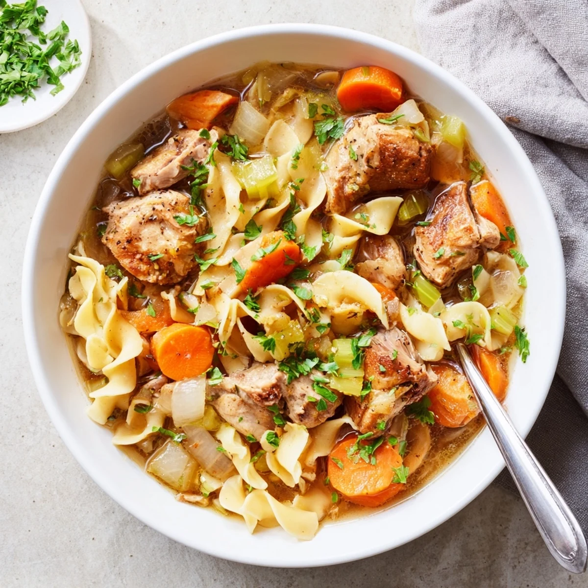 Comforting one pot chicken and noodles featuring egg noodles, carrots, and celery in savory chicken broth.
