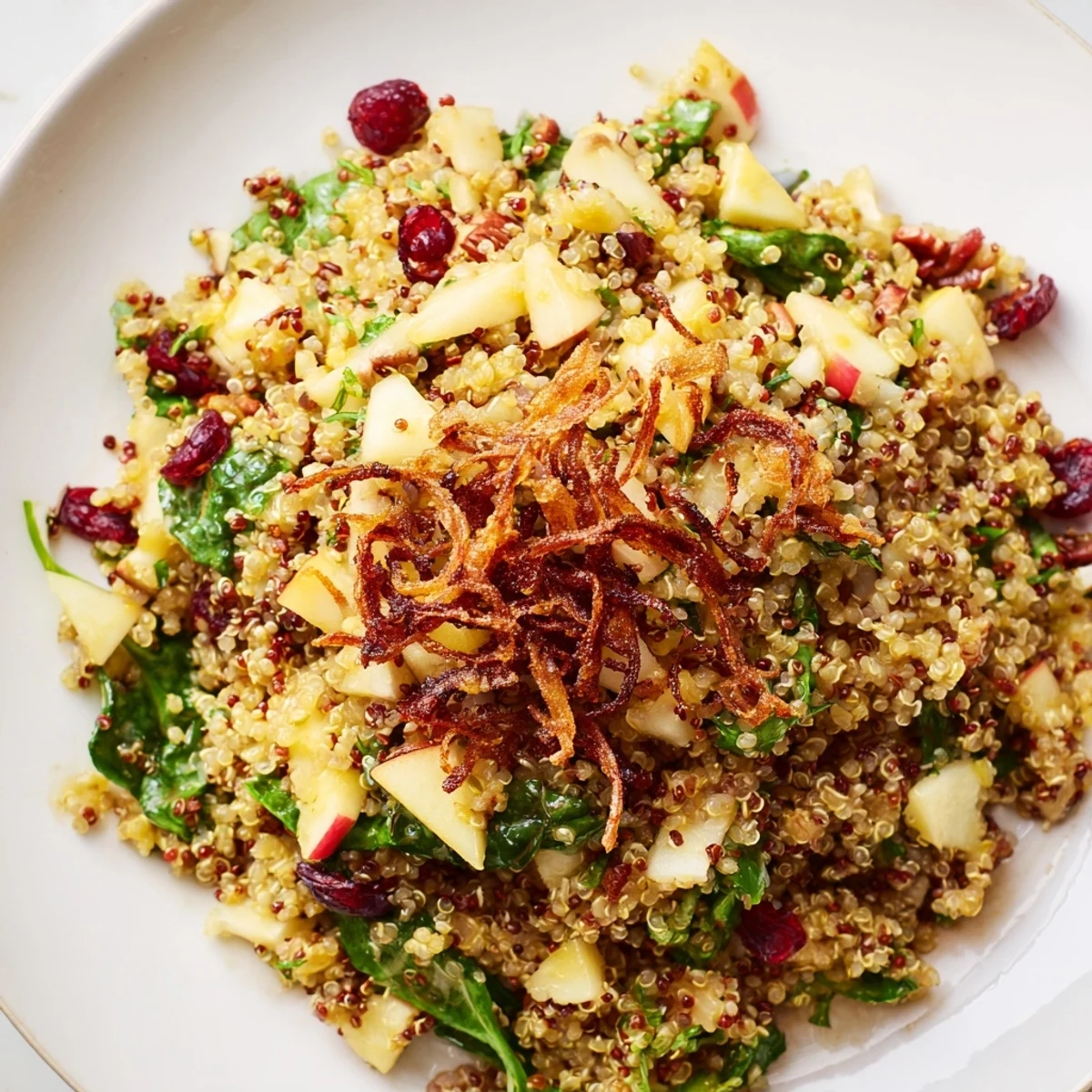 A vibrant honey mustard quinoa apple salad with crispy shallots and dried cranberries
