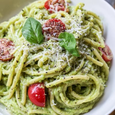 A bowl of Creamy Avocado Lime Pasta with Cherry Tomatoes, showcasing creamy avocado sauce and bright cherry tomatoes for a healthy weeknight meal.