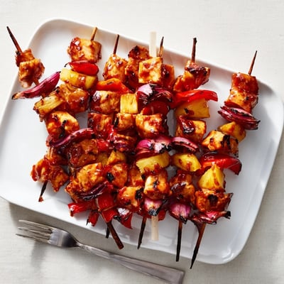 Golden Chicken and Pineapple BBQ Skewers sizzling on the grill, served over fluffy rice with fresh cilantro.